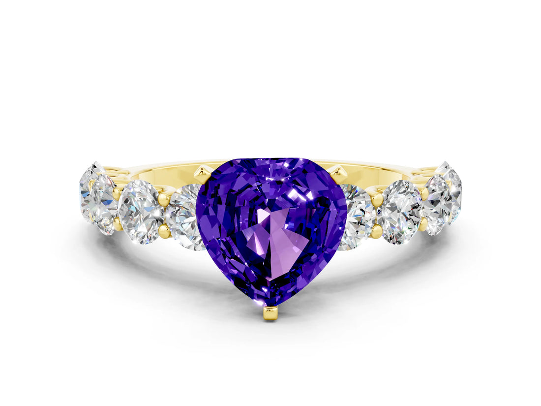 Yellow gold Heart Cut Tanzanite Prong Setting with Side Stones on a Pave Band