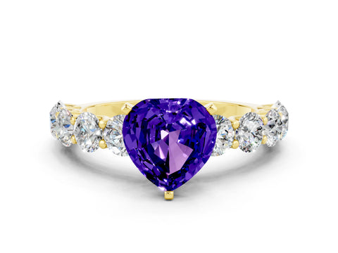Yellow gold Heart Cut Tanzanite Prong Setting with Side Stones on a Pave Band