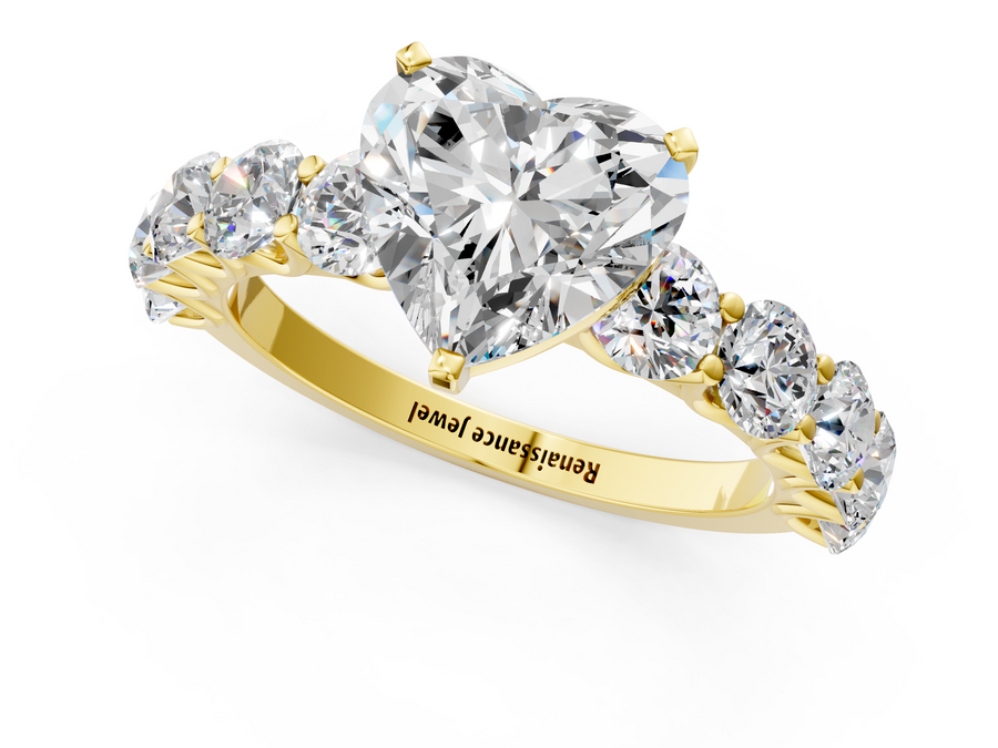 Yellow gold Heart Cut Diamond Prong Setting with Side Stones on a Pave Band