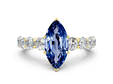 Yellow gold Marquise Cut Blue Sapphire Prong Setting with Side Stones on a Pave Band