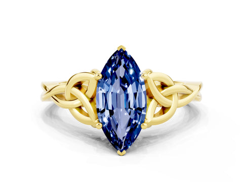 Yellow gold Marquise Cut Blue Sapphire Solitaire Engagement Ring with Celtic Knot Band and Four-Prong Setting