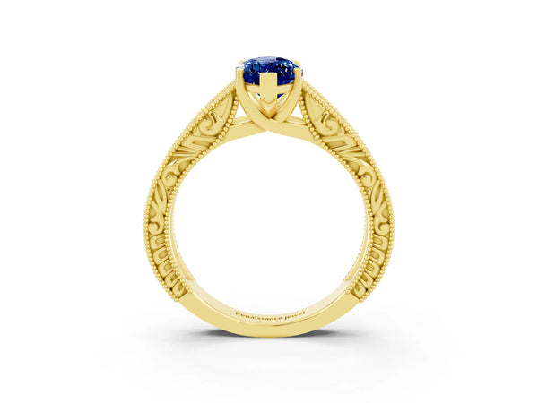 Yellow gold Marquise Cut Blue Sapphire Solitaire Ring with Engraved Band and Four-Prong Setting