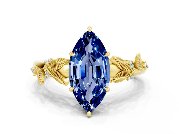 Yellow gold Marquise Cut Blue Sapphire Solitaire Ring with Leaf Motif Band and Four-Prong Setting