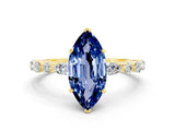 Yellow gold Marquise Cut Blue Sapphire Solitaire with Side Stones on a Pavé Band and Four-Prong Setting