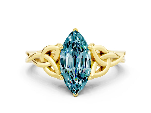 Yellow gold Marquise Cut Blue Topaz Solitaire Engagement Ring with Celtic Knot Band and Four-Prong Setting