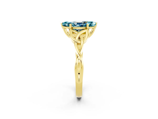 Yellow gold Marquise Cut Blue Topaz Solitaire Engagement Ring with Celtic Knot Band and Four-Prong Setting