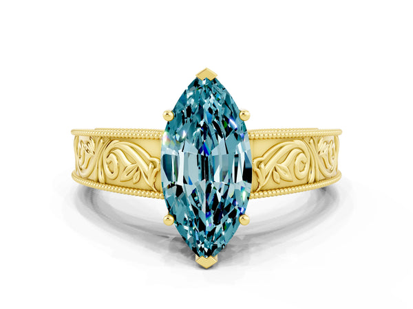 Yellow gold Marquise Cut Blue Topaz Solitaire Ring with Engraved Band and Four-Prong Setting
