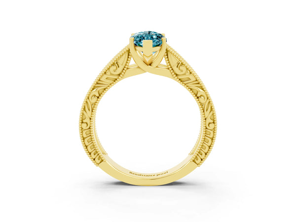 Yellow gold Marquise Cut Blue Topaz Solitaire Ring with Engraved Band and Four-Prong Setting