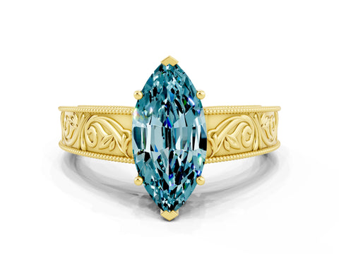 Yellow gold Marquise Cut Blue Topaz Solitaire Ring with Engraved Band and Four-Prong Setting