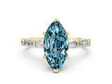 Yellow gold Marquise Cut Blue Topaz Solitaire with Side Baguettes and Channel Set Band