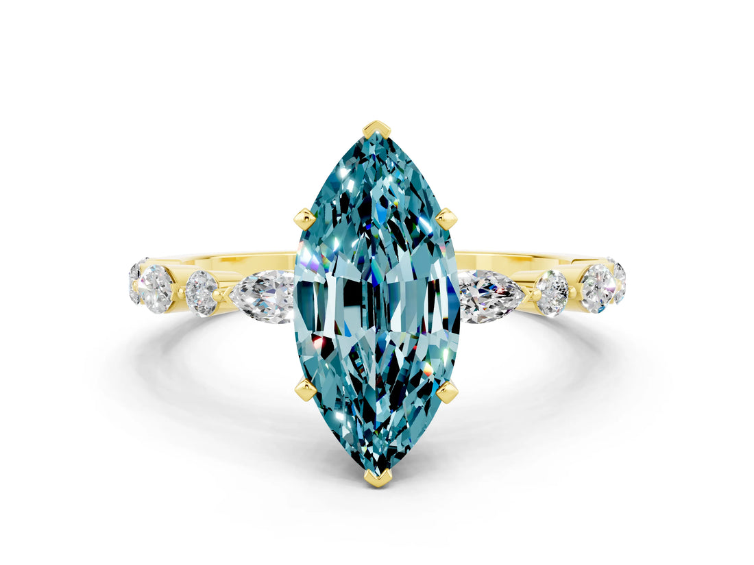 Yellow gold Marquise Cut Blue Topaz Solitaire with Side Stones on a Pavé Band and Four-Prong Setting