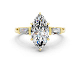 Yellow gold Marquise Cut Cut Diamond Ring with Tapered Baguette Side Stones in Four-Prong Setting