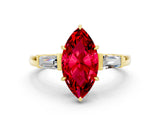 Yellow gold Marquise Cut Cut Diamond Ring with Tapered Baguette Side Stones in Four-Prong Setting