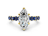 Yellow gold Marquise Cut Diamond Side Stone Solitaire Ring with Round with Blue Sapphire side stone and Four-Prong Setting