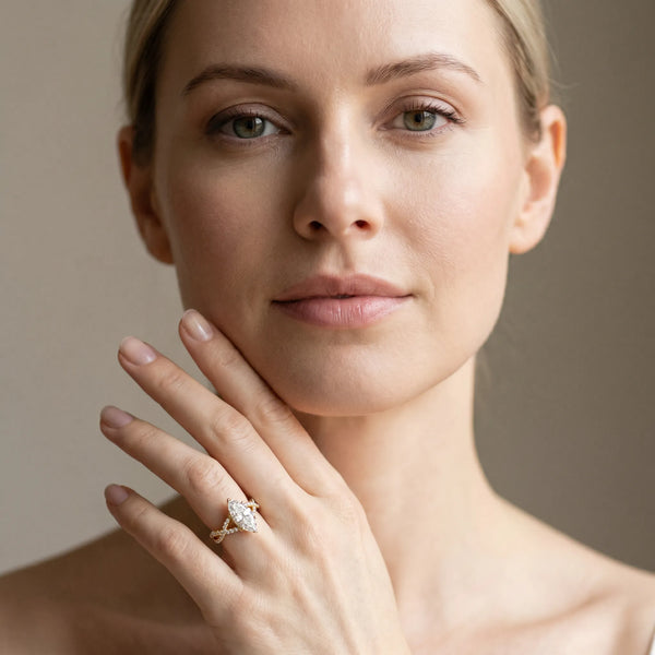 Yellow gold Marquise Cut Diamond Solitaire Ring with Four-Prong Setting and Twisted Pavé Band
