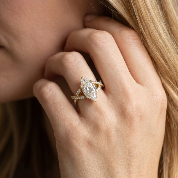 Yellow gold Marquise Cut Diamond Solitaire Ring with Four-Prong Setting and Twisted Pavé Band