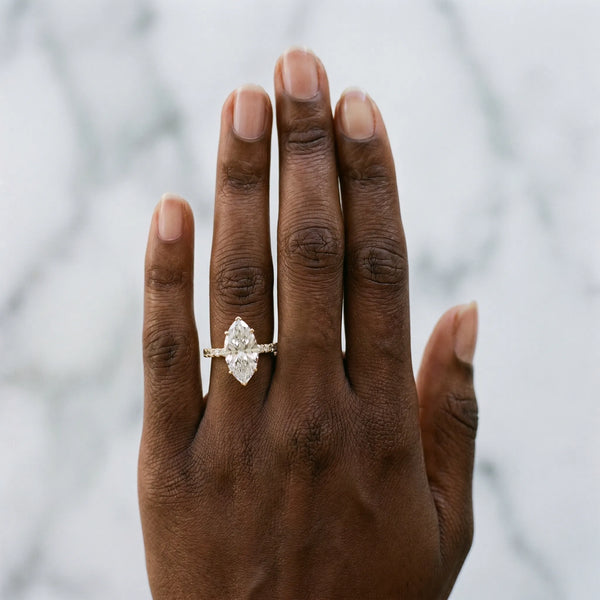 Yellow gold Marquise Cut Diamond Solitaire Ring with Pavé Accents and Four-Prong Setting