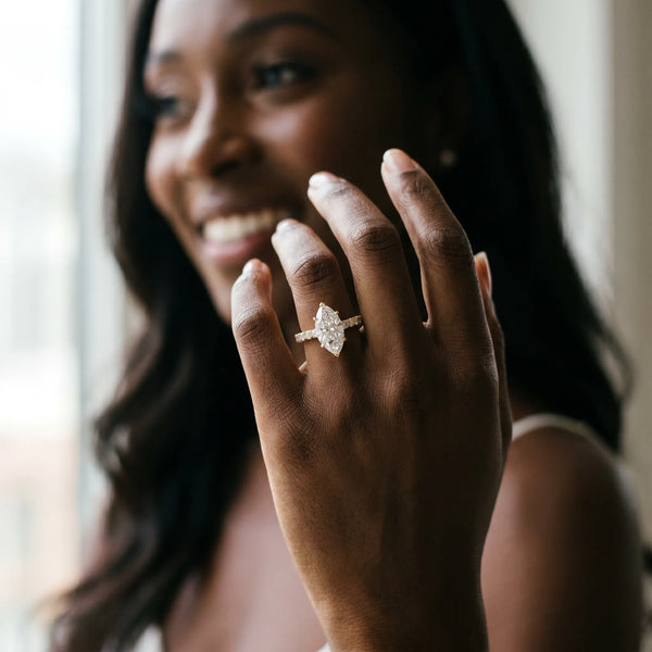 Yellow gold Marquise Cut Diamond Solitaire Ring with Pavé Accents and Four-Prong Setting