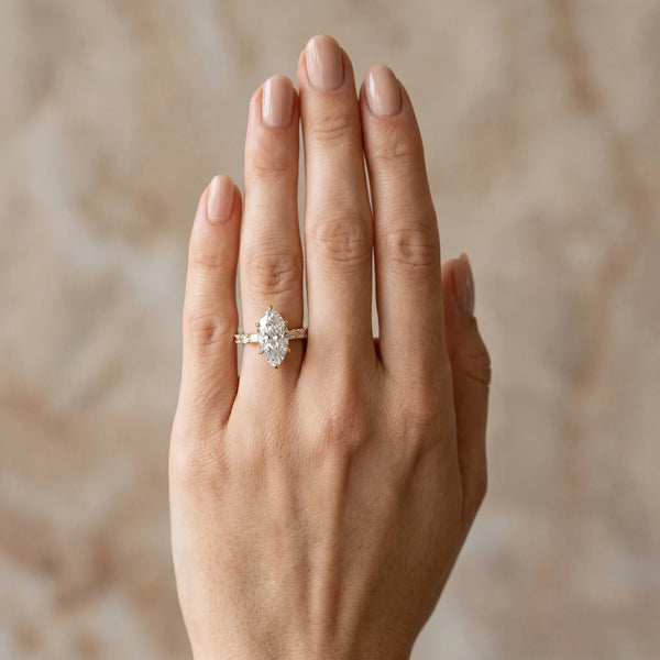 Yellow gold Marquise Cut Diamond Solitaire with Side Baguettes and Channel Set Band