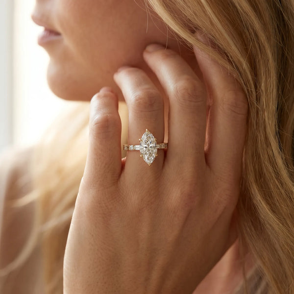 Yellow gold Marquise Cut Diamond Solitaire with Side Baguettes and Channel Set Band