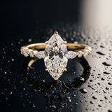 Yellow gold Marquise Cut Diamond Solitaire with Side Stones on a Pavé Band and Four-Prong Setting_112