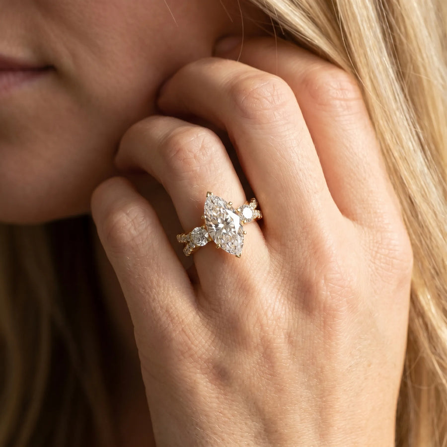 Yellow gold Marquise Cut Diamond Three-Stone Ring with Pavé Split Shank and Four-Prong Setting