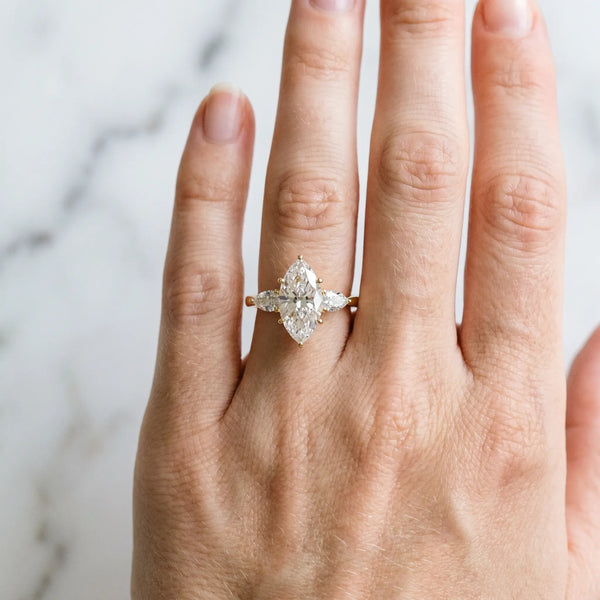 18K Yellow Gold 1.30 Carat D VS1 Marquise Diamond Three-Stone Ring with Pear Side Stones and Prong Setting