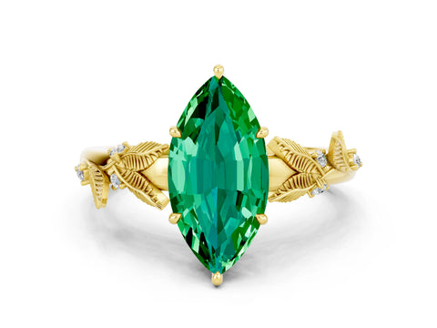 Yellow gold Marquise Cut Emerald Solitaire Ring with Leaf Motif Band and Four-Prong Setting