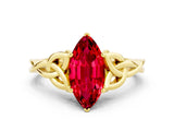Yellow gold Marquise Cut Ruby Solitaire Engagement Ring with Celtic Knot Band and Four-Prong Setting