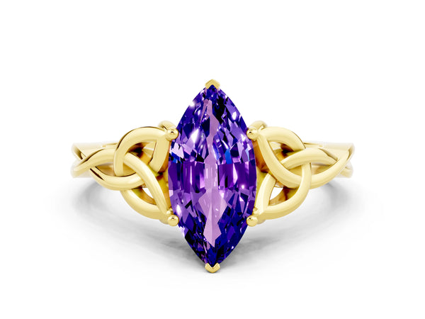 Yellow gold Marquise Cut Tanzanite Solitaire Engagement Ring with Celtic Knot Band and Four-Prong Setting