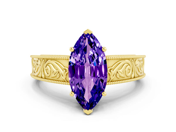 Yellow gold Marquise Cut Tanzanite Solitaire Ring with Engraved Band and Four-Prong Setting