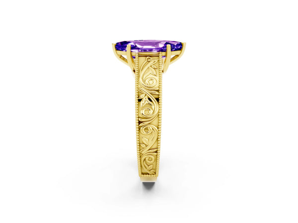 Yellow gold Marquise Cut Tanzanite Solitaire Ring with Engraved Band and Four-Prong Setting