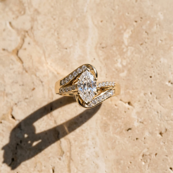 Yellow gold Marquise Solitaire Bypass Diamond Engagement Ring with Channel-Set Band and Four-Prong Setting
