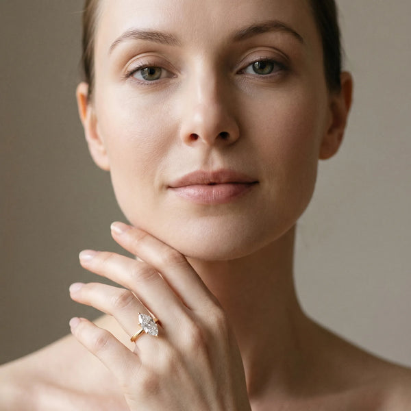 Yellow gold Marquise Solitaire Diamond Engagement Ring with Four-Prong Setting on a Classic Band