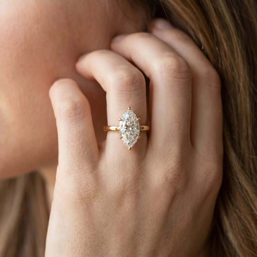 Yellow gold Marquise Solitaire Diamond Engagement Ring with Four-Prong Setting on a Classic Band