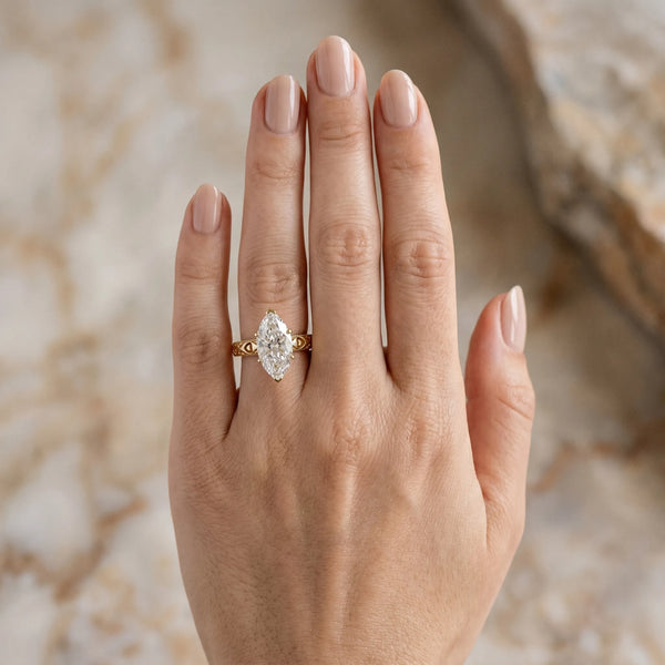 Yellow gold Marquise Solitaire Diamond Engagement Ring with XO Engraved Band and Four-Prong Setting