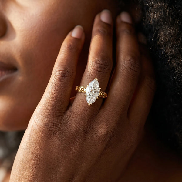 Yellow gold Marquise Solitaire Diamond Engagement Ring with XO Engraved Band and Four-Prong Setting