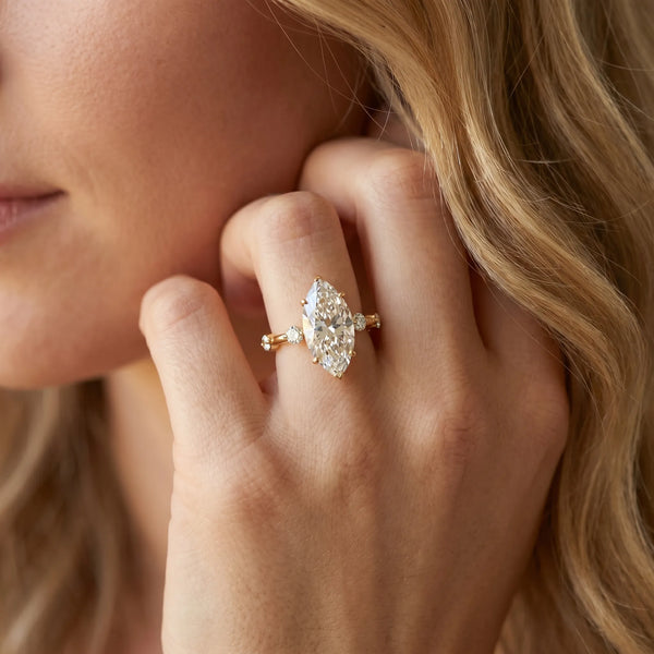 Yellow gold Marquise Solitaire Diamond Ring with Bezel Set Side Stones and Prong Setting