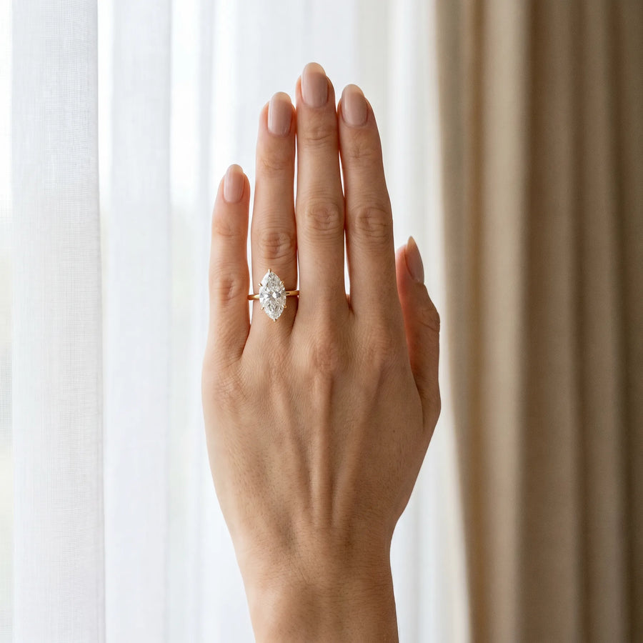 Yellow gold Marquise Solitaire Diamond Ring with Four-Prong Setting on a Plain Band