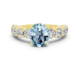 Yellow gold Oval Cut Aquamarine Prong Setting with Side Stones on a Pave Band