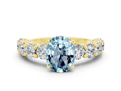 Yellow gold Oval Cut Aquamarine Prong Setting with Side Stones on a Pave Band