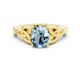 Yellow gold Oval Cut Aquamarine Solitaire Engagement Ring with Celtic Knot Band and Four-Prong Setting