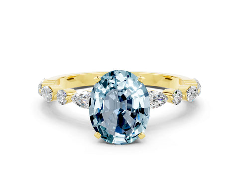Yellow gold Oval Cut Aquamarine Solitaire with Side Stones on a Pavé Band and Four-Prong Setting