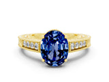 Yellow gold Oval Cut Blue Sapphire Engagement Ring with Milgrain Channel Set Band and Prong Setting