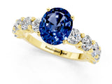 Yellow gold Oval Cut Blue Sapphire Prong Setting with Side Stones on a Pave Band_1