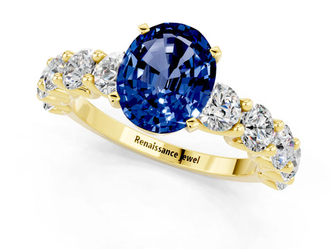 Yellow gold Oval Cut Blue Sapphire Prong Setting with Side Stones on a Pave Band_1