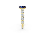 Yellow gold Oval Cut Blue Sapphire Prong Setting with Side Stones on a Pave Band_2