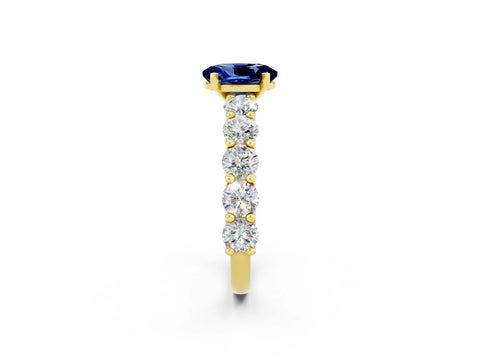 Yellow gold Oval Cut Blue Sapphire Prong Setting with Side Stones on a Pave Band_2