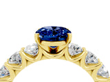 Yellow gold Oval Cut Blue Sapphire Prong Setting with Side Stones on a Pave Band_4