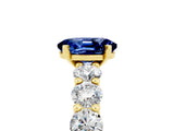 Yellow gold Oval Cut Blue Sapphire Prong Setting with Side Stones on a Pave Band_5